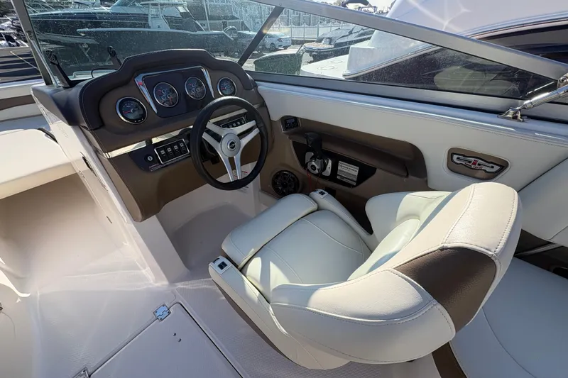 Slide: The Image of Interior view of a 2015 Chaparral 246 SSi boat cockpit with steering wheel and gauges. - 9