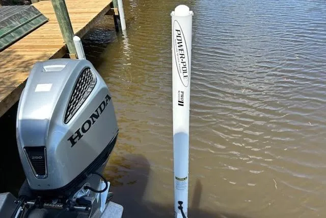 Slide: The Image of 2020 Avalon 2685 LSZ QL pontoon boat with Honda outboard motor and swim ladder. - 10