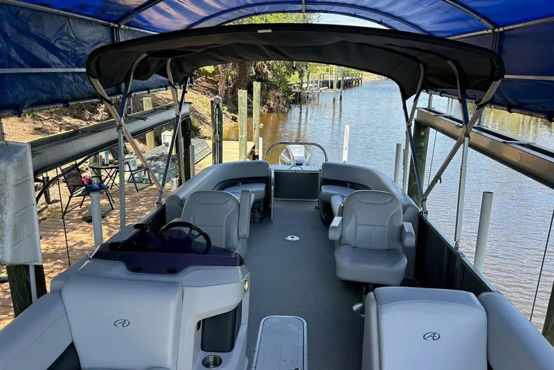 Slide: The Image of 2020 Avalon 2685 LSZ QL pontoon boat docked, showcasing sleek design and comfortable seating. - 2