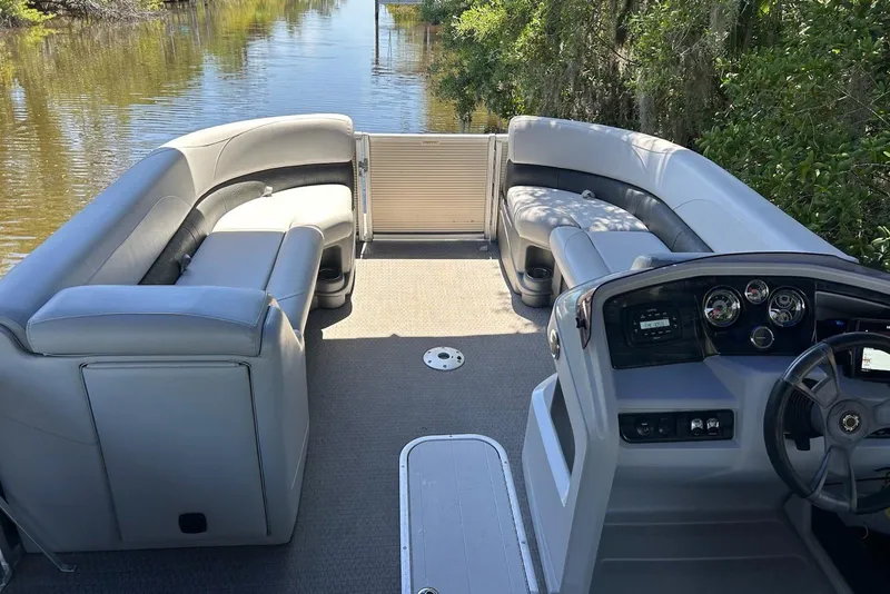 Slide: The Image of 2020 Avalon 2685 LSZ QL pontoon boat docked under a blue canopy. - 3