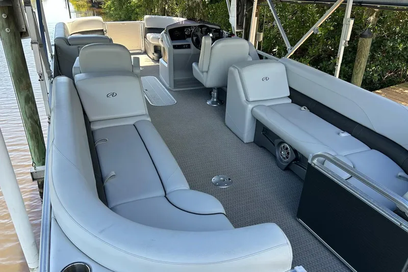 Slide: The Image of 2020 Avalon 2685 LSZ QL pontoon boat interior with plush seating and steering console. - 4