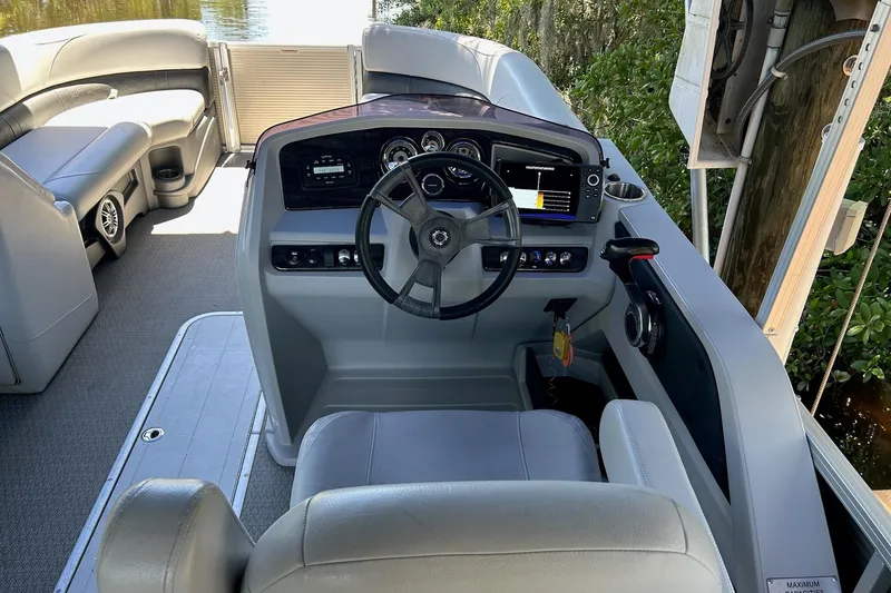 Slide: The Image of 2020 Avalon 2685 LSZ QL boat interior with gray cushioned seating and speaker. - 6