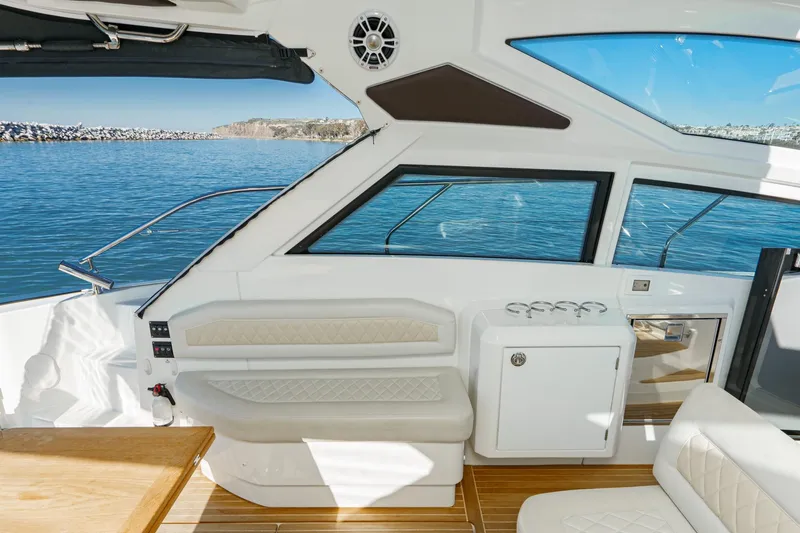 Slide: The Image of Interior of 2018 Beneteau Gran Turismo 40 yacht with elegant seating and ocean view. - 10