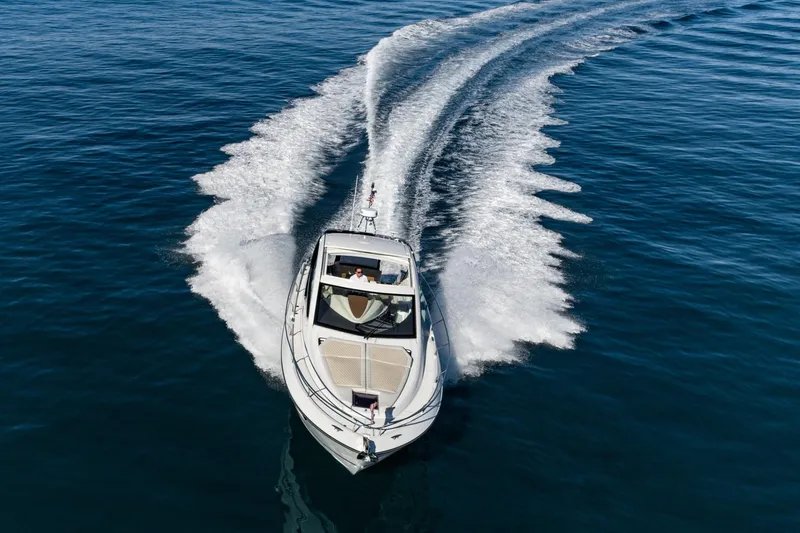Slide: The Image of 2018 Beneteau Gran Turismo 40 cruising on open water, creating dynamic wake patterns. - 11