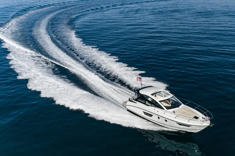 Slide: The Image of 2018 Beneteau Gran Turismo 40 yacht cruising on open water, leaving a wake trail. - 14