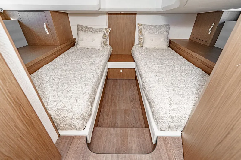 Slide: The Image of Twin beds in the 2018 Beneteau Gran Turismo 40 cabin, featuring elegant wood finishes. - 19