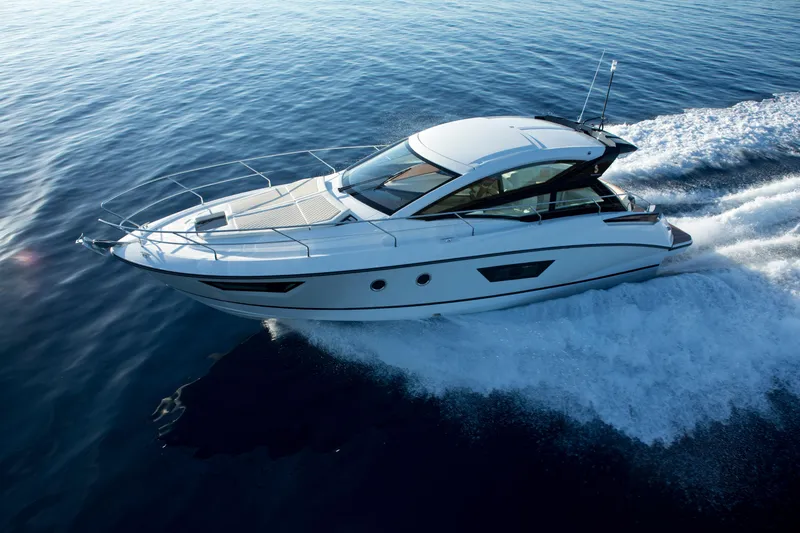 Slide: The Image of 2018 Beneteau Gran Turismo 40 yacht cruising on open water, rear view. - 2