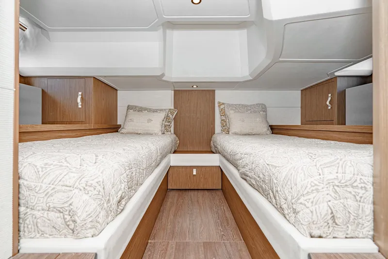 Slide: The Image of Interior cabin of 2018 Beneteau Gran Turismo 40 with twin beds and wooden accents. - 20