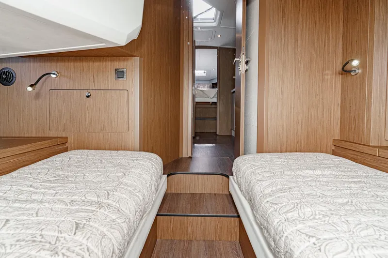 Slide: The Image of 2018 Beneteau Gran Turismo 40 cabin interior with twin beds and wooden finish. - 23