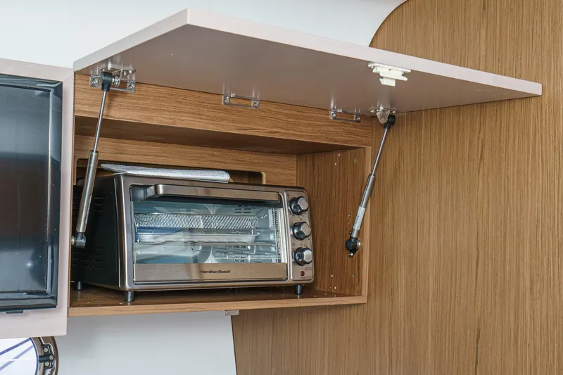 Slide: The Image of Toaster oven in wooden cabinet on 2018 Beneteau Gran Turismo 40 yacht. - 24