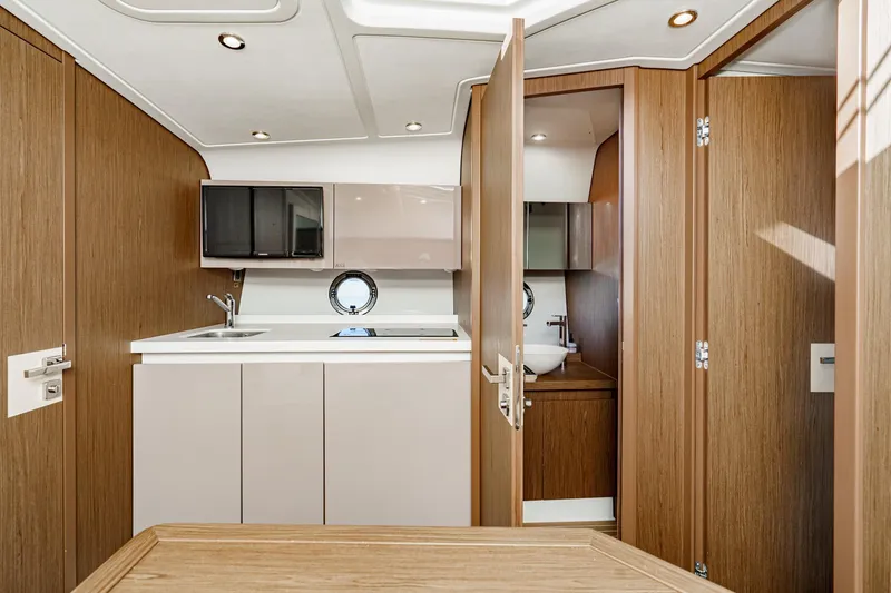 Slide: The Image of Interior of 2018 Beneteau Gran Turismo 40 yacht, featuring modern kitchen and bathroom design. - 29
