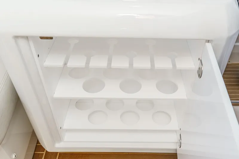 Slide: The Image of Open storage compartment on 2018 Beneteau Gran Turismo 40 yacht, featuring circular cutouts. - 31