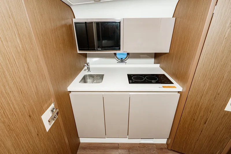 Slide: The Image of Compact kitchen area in a 2018 Beneteau Gran Turismo 40 yacht, featuring modern appliances. - 38