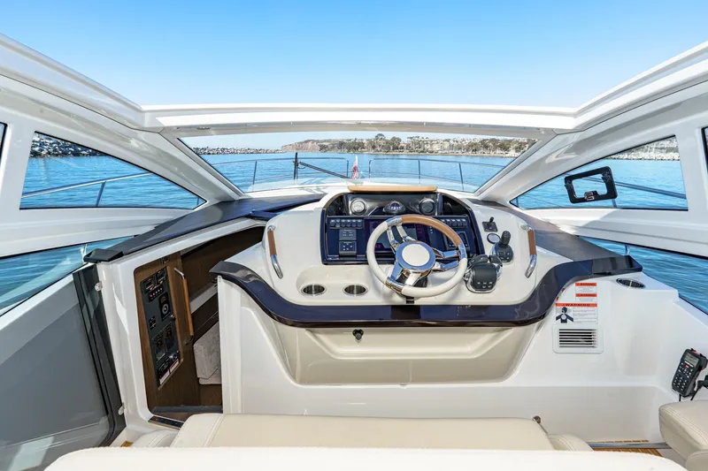 Slide: The Image of Cockpit view of 2018 Beneteau Gran Turismo 40 yacht with modern controls and ocean backdrop. - 39