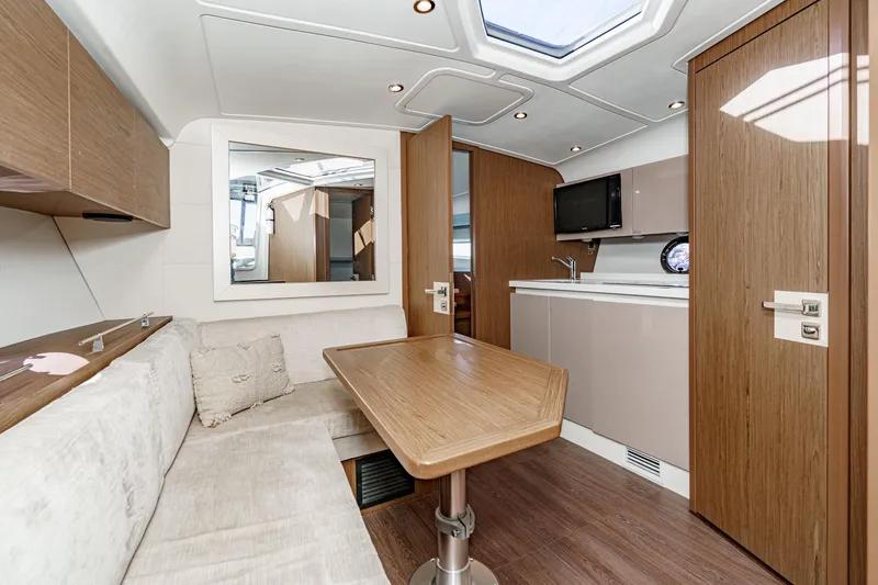 Slide: The Image of Interior of 2018 Beneteau Gran Turismo 40 yacht with modern kitchen and seating area. - 42