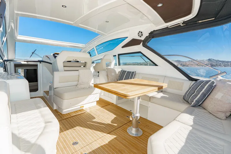 Slide: The Image of Luxurious interior of 2018 Beneteau Gran Turismo 40 yacht with elegant seating and wooden table. - 56