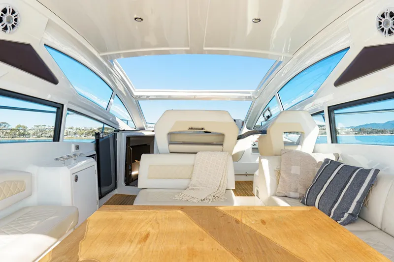 Slide: The Image of Luxurious interior of 2018 Beneteau Gran Turismo 40 yacht with elegant seating and panoramic windows. - 57