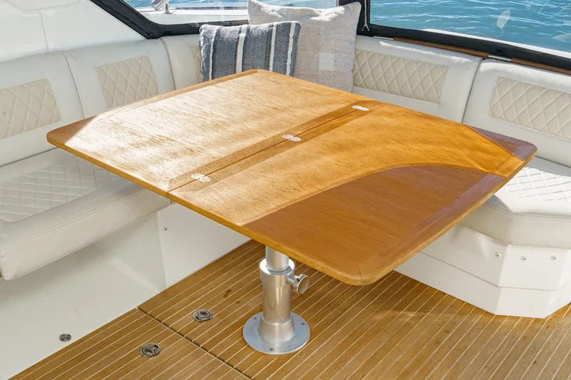 Slide: The Image of Luxury seating area on 2018 Beneteau Gran Turismo 40 yacht with wooden table. - 7