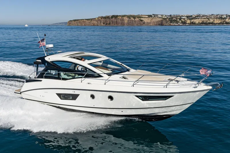 Slide: The Image of 2018 Beneteau Gran Turismo 40 yacht cruising on open water, scenic coastal backdrop. - 8