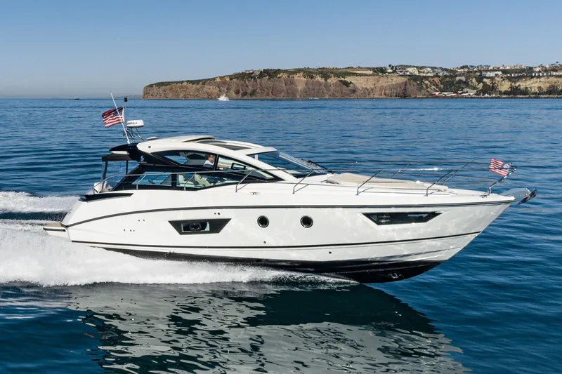 Slide: The Image of 2018 Beneteau Gran Turismo 40 yacht cruising on open water with scenic coastline backdrop. - 9