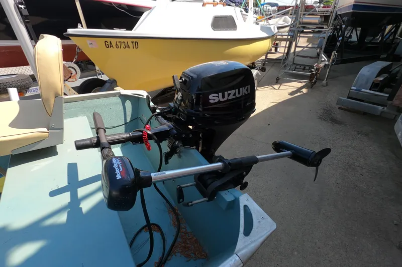 Slide: The Image of 1969 Thundercraft 14 boat with Suzuki outboard motor and trolling motor in a marina. - 3
