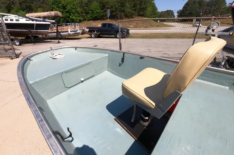 Slide: The Image of 1969 Thundercraft 14 boat interior with beige seat, parked outdoors. - 5