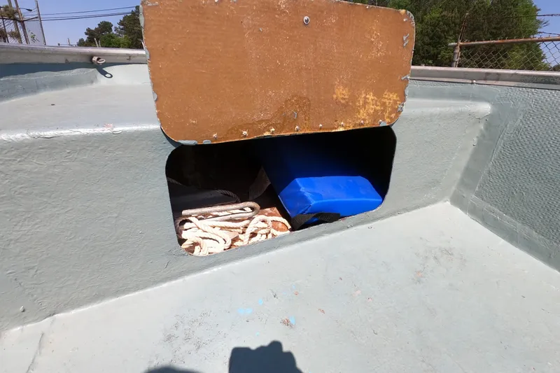 Slide: The Image of Storage compartment on a 1969 Thundercraft 14 boat with ropes and a blue item. - 6