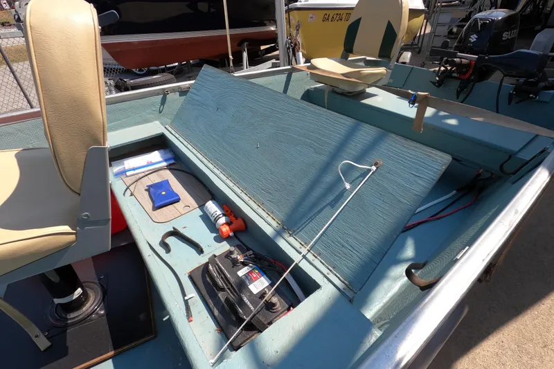 Slide: The Image of 1969 Thundercraft 14 boat interior with seats, battery, and equipment. - 8