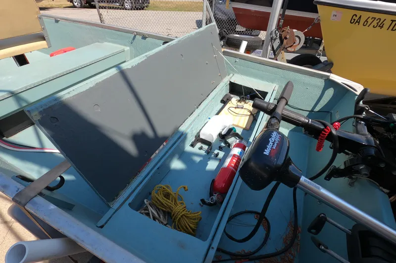 Slide: The Image of 1969 Thundercraft 14 boat interior with motor, fire extinguisher, and rope. - 9