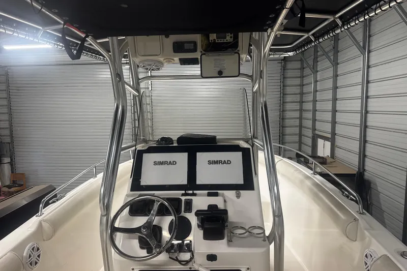 Slide: The Image of 2008 Century 2600 Center Console boat with dual Simrad displays in a storage facility. - 55