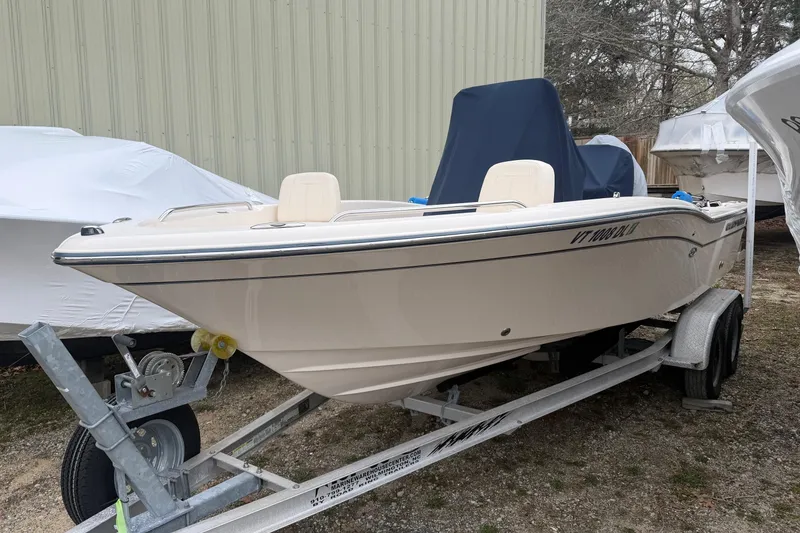 The Image of 2016 Grady-White 191 Coastal Explorer boat on trailer, parked outside a building. - 0
