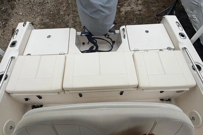 Slide: The Image of 2016 Grady-White 191 Coastal Explorer boat interior with cushioned seating and storage compartments. - 7
