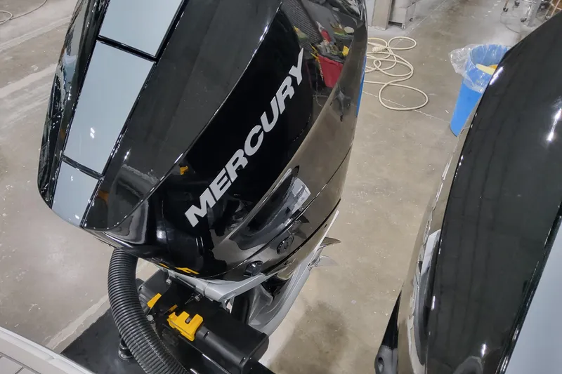 Slide: The Image of 2026 Formula 310 Bowrider OB with Mercury outboard engine in a workshop setting. - 15