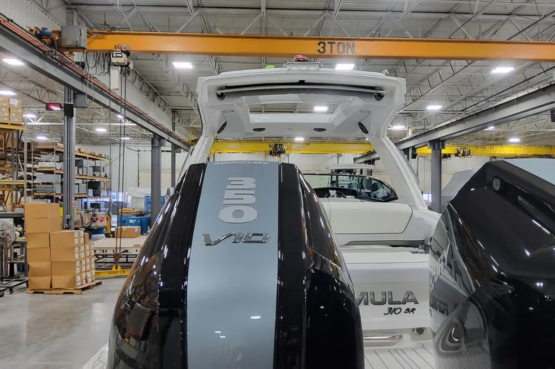 Slide: The Image of 2026 Formula 310 Bowrider OB with dual 350 V10 engines in a factory setting. - 16