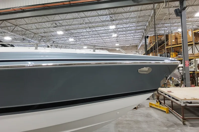 Slide: The Image of 2026 Formula 310 Bowrider OB boat in a warehouse, showcasing sleek design and modern features. - 3
