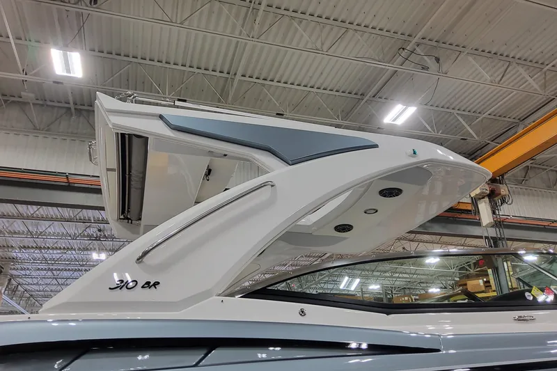 Slide: The Image of 2026 Formula 310 Bowrider OB boat in a warehouse, showcasing sleek design and modern features. - 5