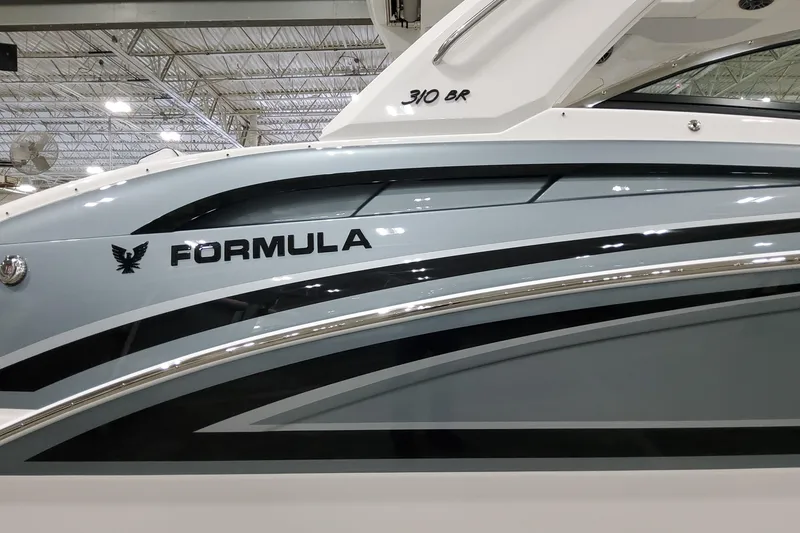 Slide: The Image of 2026 Formula 310 Bowrider OB boat side view with sleek design and logo. - 6