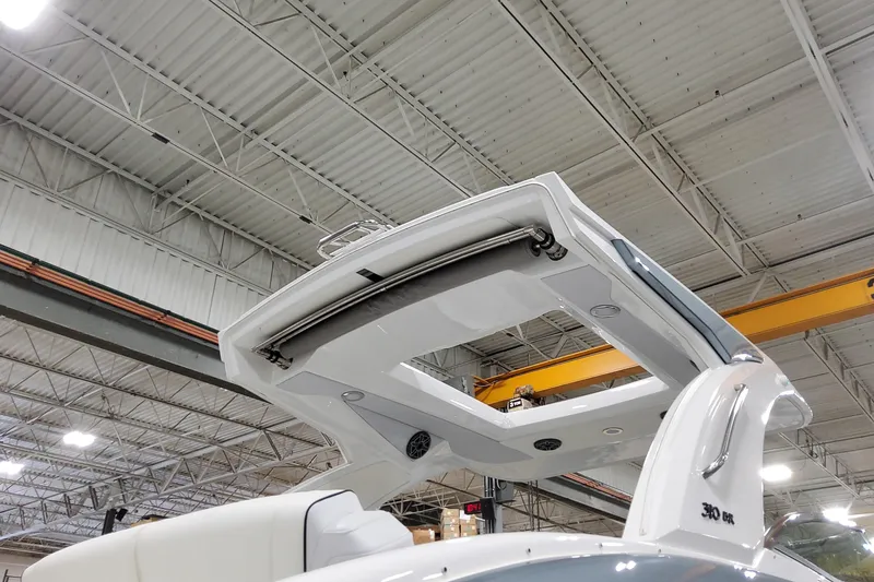 Slide: The Image of 2026 Formula 310 Bowrider OB boat in a warehouse, showcasing sleek design and modern features. - 7