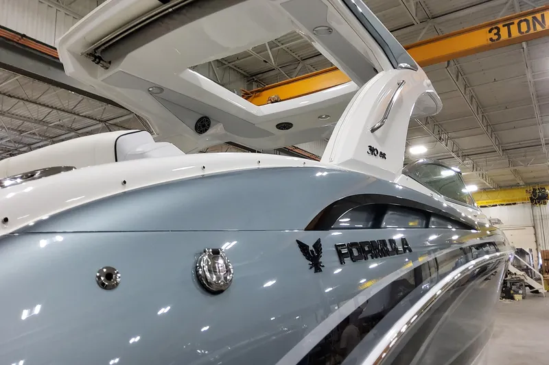 Slide: The Image of 2026 Formula 310 Bowrider OB in a showroom, showcasing sleek design and modern features. - 8