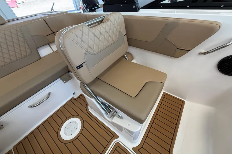 Slide: The Image of 2026 Bayliner VR6 Bowrider OB interior with tan seating and teak-style flooring. - 10