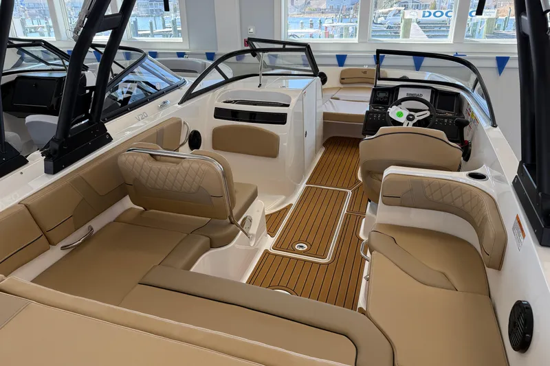 Slide: The Image of 2026 Bayliner VR6 Bowrider OB interior with tan seating and modern dashboard. - 5