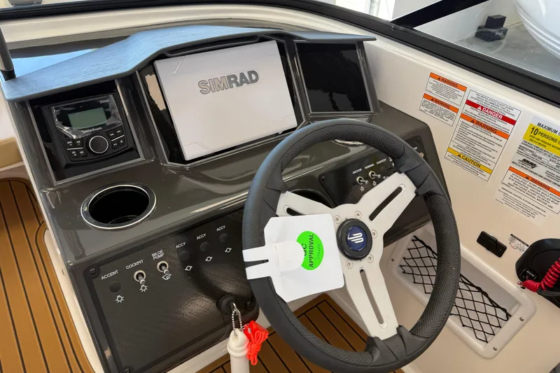 Slide: The Image of 2026 Bayliner VR6 Bowrider OB dashboard with steering wheel and Simrad display. - 6