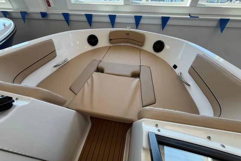 Slide: The Image of 2026 Bayliner VR6 Bowrider OB interior with beige seating and wood flooring. - 7