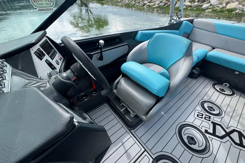 Slide: The Image of Interior of a 2017 MasterCraft NXT22 boat with blue and gray seating. - 11