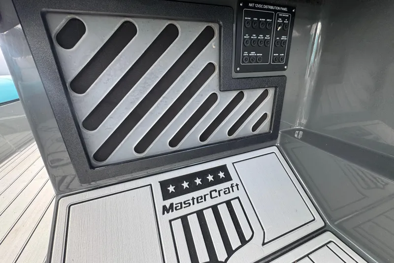 Slide: The Image of 2017 MasterCraft NXT22 interior with branded flooring and control panel. - 14