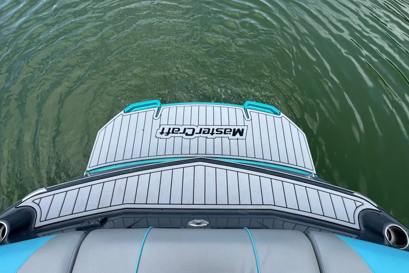 Slide: The Image of 2017 MasterCraft NXT22 boat swim platform on calm water. - 19