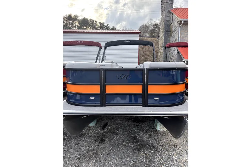 The Image of 2026 Bentley Pontoons Legacy 220 Navigator with blue and orange design, docked outdoors. - 0