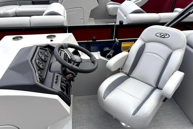 Slide: The Image of 2026 Bentley Pontoons Legacy 220 Navigator helm with luxurious captain's chair and control panel. - 8
