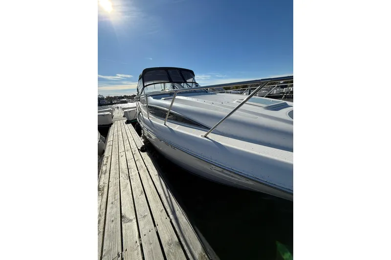 Slide: The Image of 2000 Bayliner 3055 Ciera Sunbridge DX/LX docked under clear blue sky. - 10