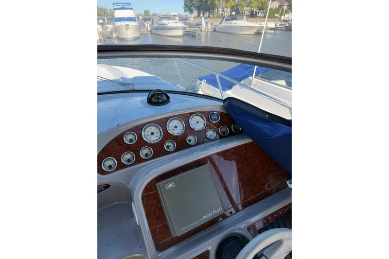 Slide: The Image of Dashboard of a 2000 Bayliner 3055 Ciera Sunbridge DX/LX boat at a marina. - 2
